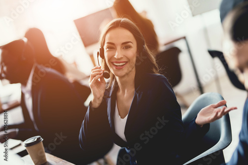 Caucasian girl looks at work in the call center. photo