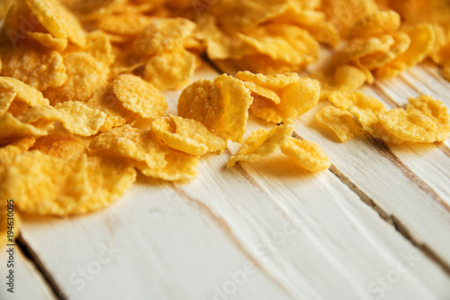 Golden crisp cereal for Breakfast on a white wooden background photo