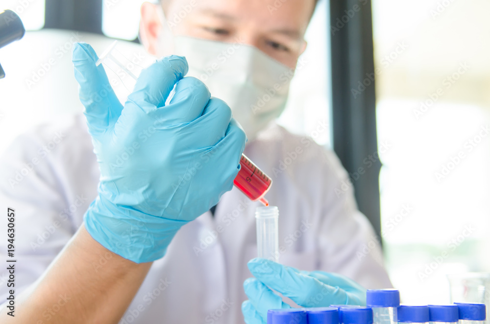 closeup hand of scientist in lab . Hand hold syringe blood in tube , Testing result Medical or chemical background closeup hand of scientist in lab . Hand hold syringe blood in tube , Testing result Medical or chemical background