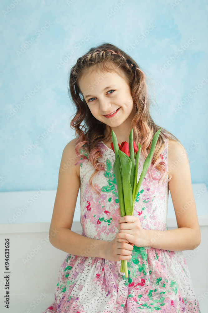 Adorable smiling teenager girl with tulips Adorable smiling teenager girl with tulips