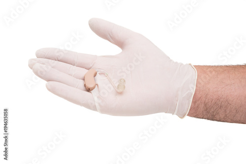 a hearing aid in the doctor's hand