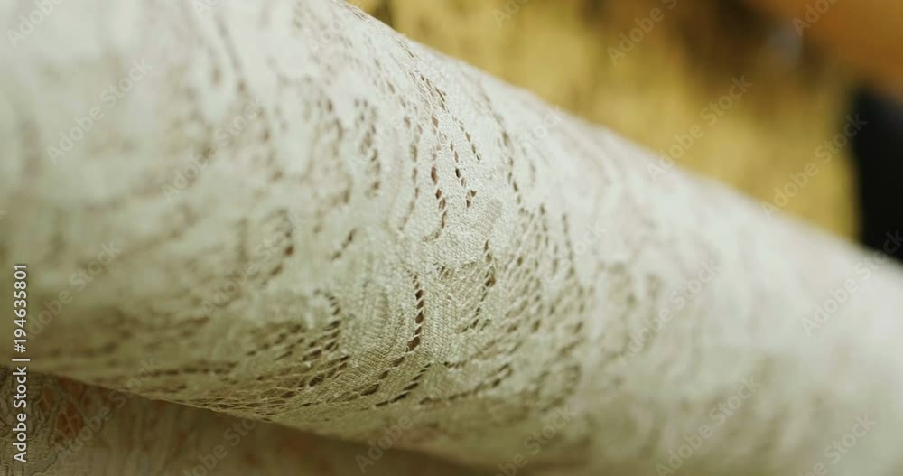 Macro shot of a lace, fabric used to make elegant wedding dresses for the wedding day. Concept of: tailoring, colors, bride and marriage Macro shot of a lace, fabric used to make elegant wedding dresses for the wedding day. Concept of: tailoring, colors, bride and marriage