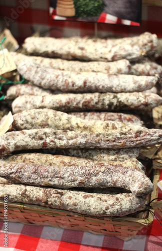 basket with dried sausages on a sales counter