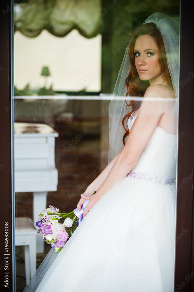 Beautiful smiling bride behind the glass Beautiful smiling bride behind the glass