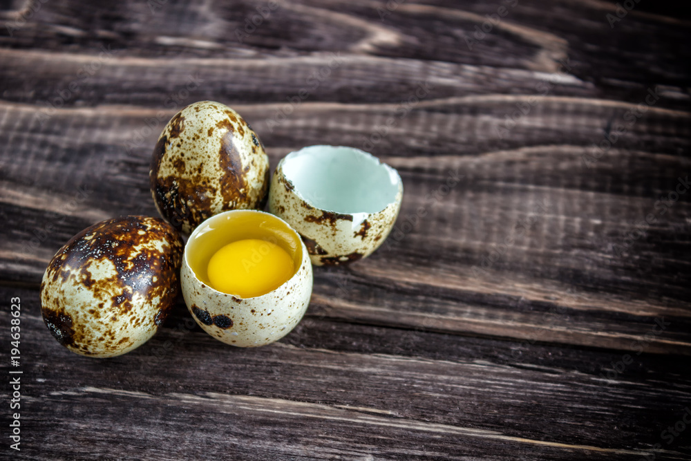 Quail eggs on a wooden background, egg yolk, symbol of the Easter season. Healthy eating. Quail eggs on a wooden background, egg yolk, symbol of the Easter season. Healthy eating.