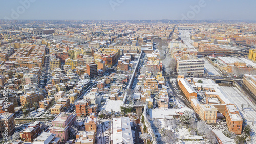 Aerial view of a group of buildings in the Tuscolana district in Rome  Italy. The buildings and streets are unusually covered with snow and ice.The roofs are passable and with antennas and TV dishes.