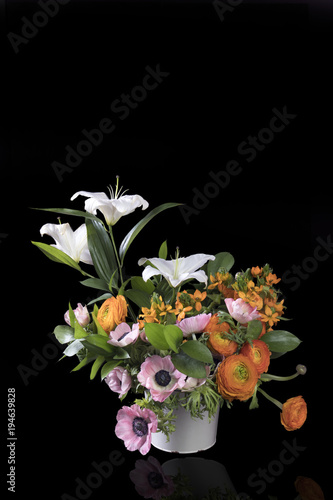 wedding bouquet of buttercups  anemones and Ruscus on the black background