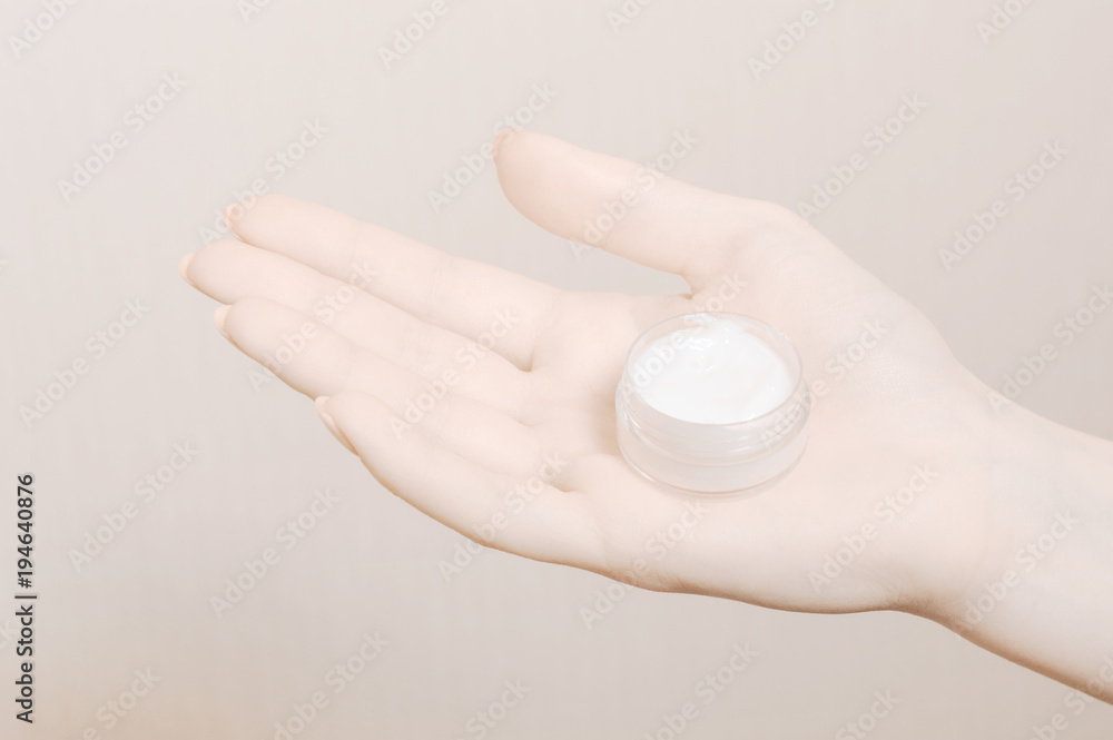Young woman's hands with moisturizer creme Young woman's hands with moisturizer creme