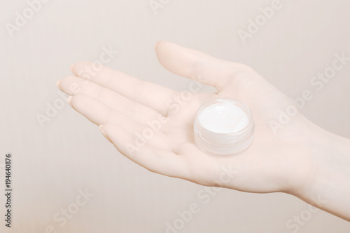 Young woman s hands with moisturizer creme