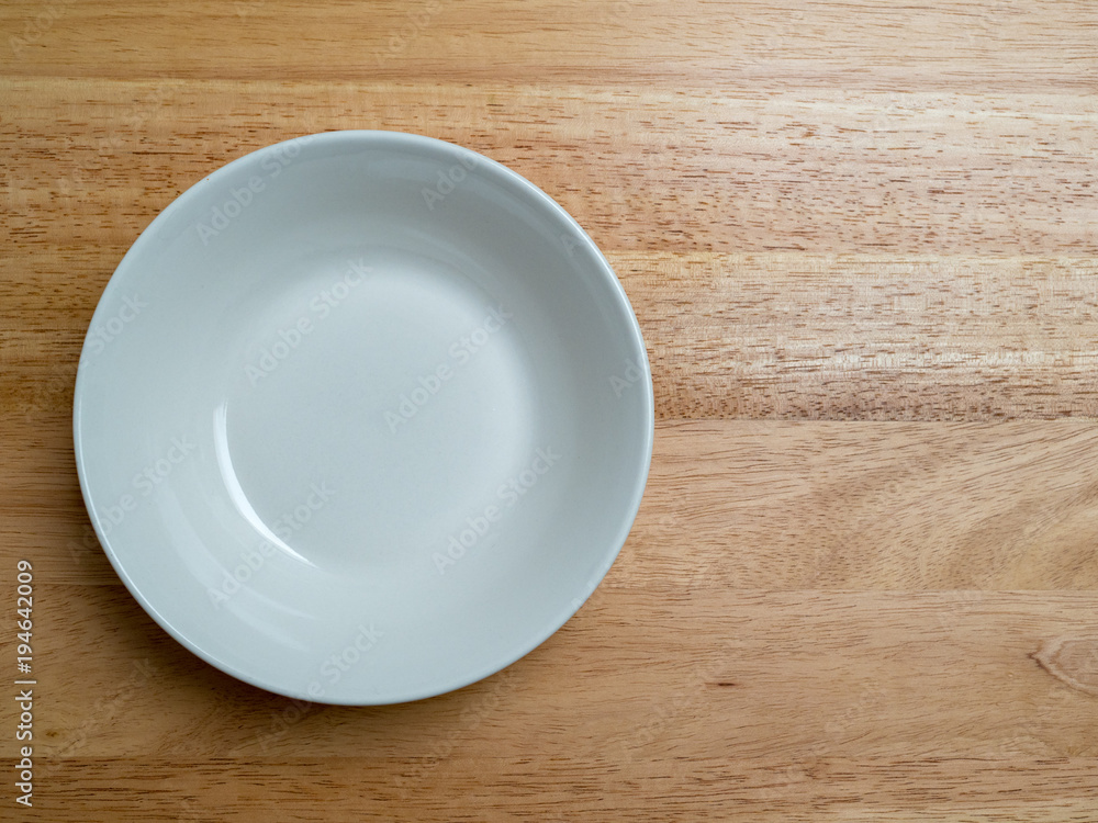 Empty porcelain bowl on wooden chopping block Empty porcelain bowl on wooden chopping block