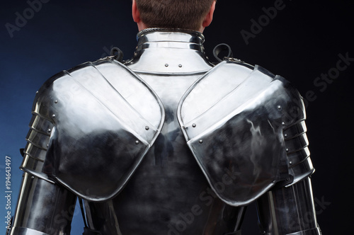 Metal knight's armor, body protection, dark background.