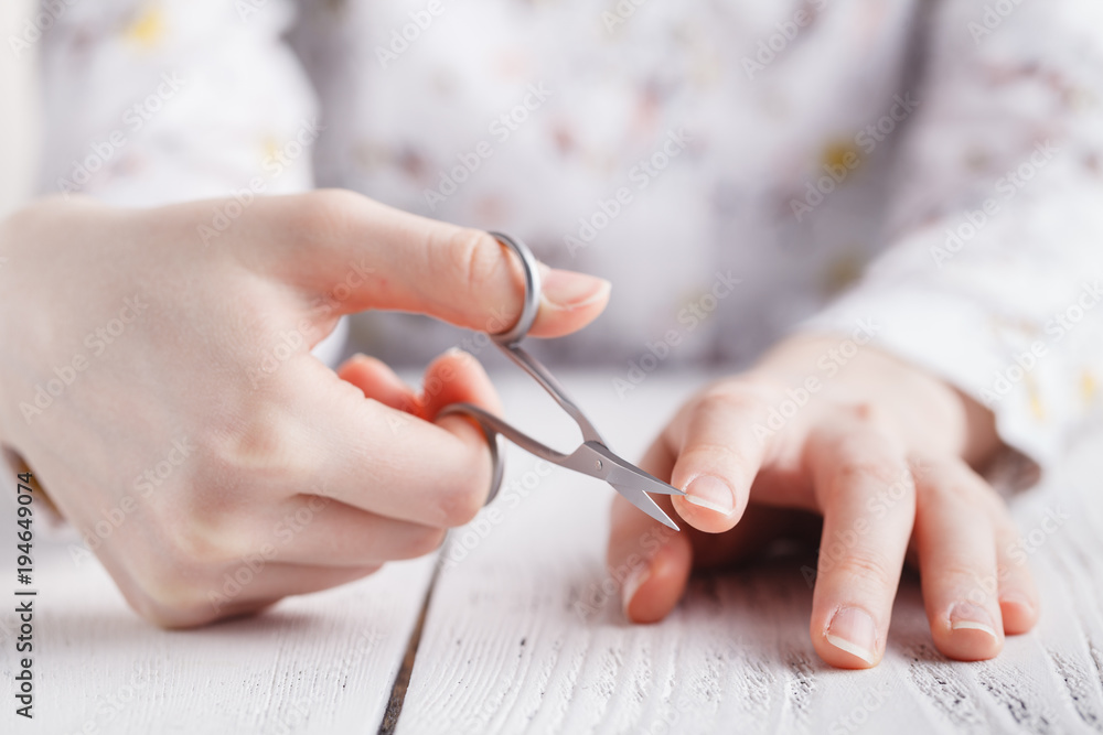 beauty salon, manicure applying, cutting the cuticle with scissors beauty salon, manicure applying, cutting the cuticle with scissors