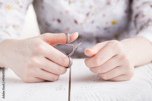 Health and personal care: Hand holding scissors for manicure