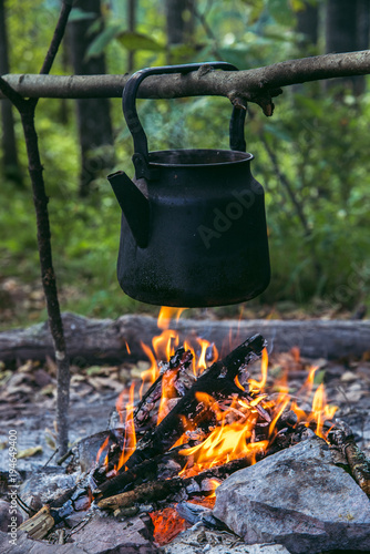 Camp fire cooking. Old vintage boiling teapot
