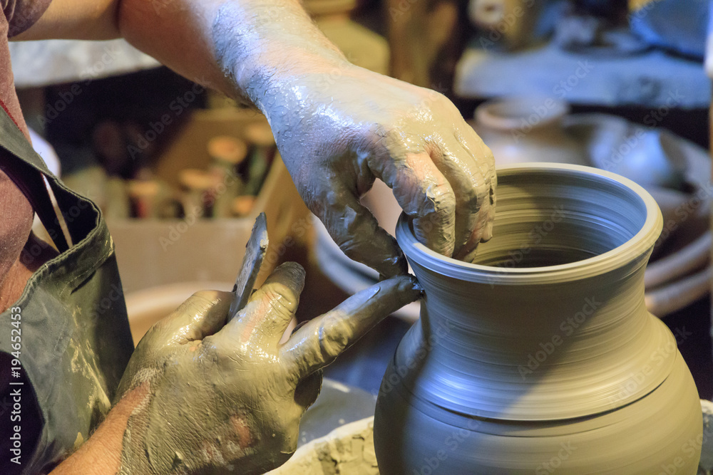 Europe, Romania. Baia Sprie. Pottery shop. Throwing clay to make pots.  Stock Photo | Adobe Stock
