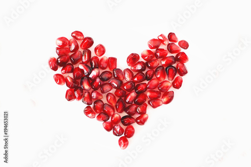 heart of red pomegranate seeds on a white background, Valentine