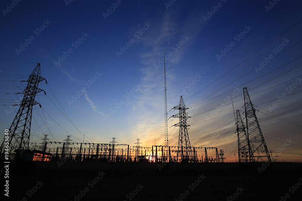 Fototapeta premium A high voltage substation in the sky at sunrise