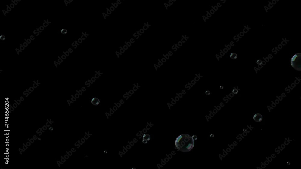 Soap bubbles fall down on black background Soap bubbles fall down on black background