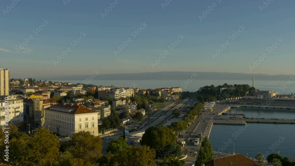 Pan right view of buildings and a train station Pan right view of buildings and a train station
