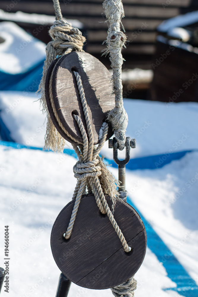 Ropes and blocks on the deck of a sailing ship and fishing boat. Rowing accessories.