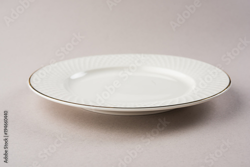 Empty white ceramic round plate isolated on white background
