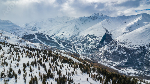 Scenic view of the Alps with a city down in the valley  photo