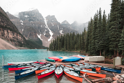 Canoes await use on Moraine Lake of Lake Louise in Banff National Park, Alberta Canada