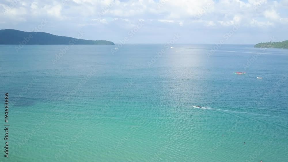 Aerial camera showing boats plying the waters off Koh Rong Samloen at sunset. Aerial camera showing boats plying the waters off Koh Rong Samloen at sunset.