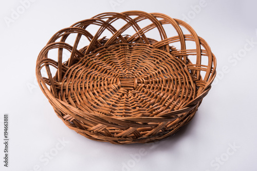 empty cane basket or tokri in hindi and topli in marathi, isolated over white background
 photo
