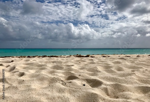 Beautiful panoramic view of an scenic untouched sand beach in Barbados (Caribbean Island of the West Indies) with a blue sky and white clouds on a sunny day