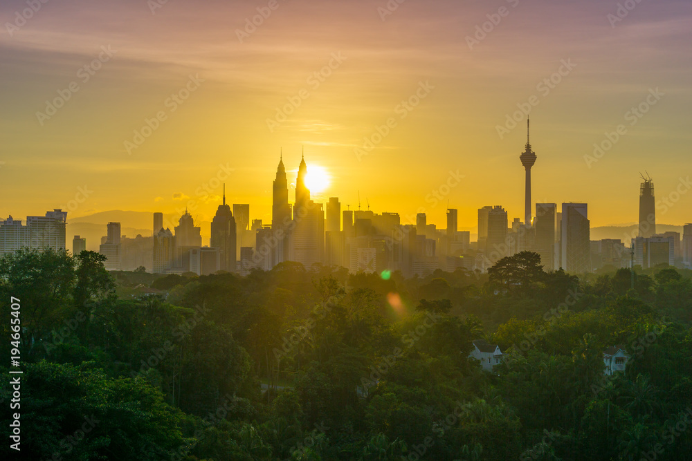 Majestic sunrise over Petronas Twin Towers and surrounded buildings in downtown Kuala Lumpur, Malaysia