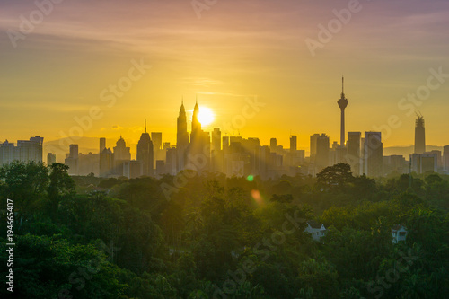 Majestic sunrise over Petronas Twin Towers and surrounded buildings in downtown Kuala Lumpur, Malaysia