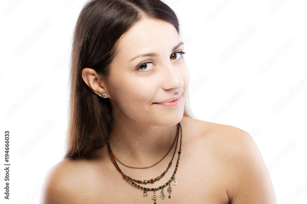 surprised brunette girl wearing a necklace with generic symbols