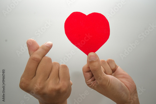 Female hand show up on white background, sign of love, love moment.