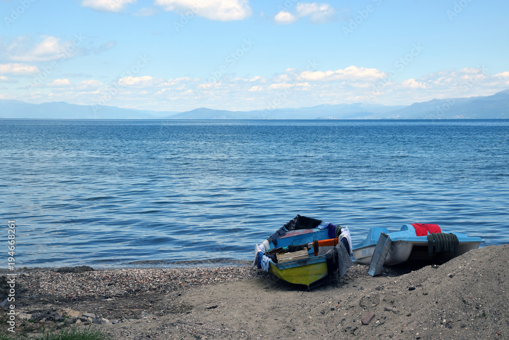 Boat and pedalo on Ohrid lake beach. Podgradec, Albania. Boat and pedalo on Ohrid lake beach. Podgradec, Albania.