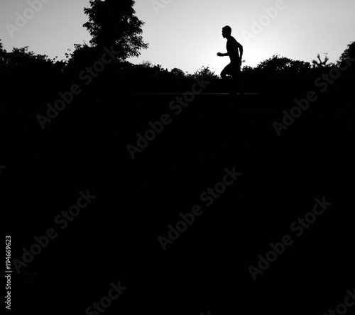 Close up the runner start from run on railroad tracks with dramatic tone, Sunset running in the evening