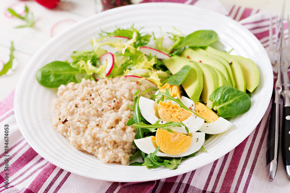 Healthy breakfast. Dietary menu. Oatmeal porridge and avocado salad and eggs. Healthy breakfast. Dietary menu. Oatmeal porridge and avocado salad and eggs.