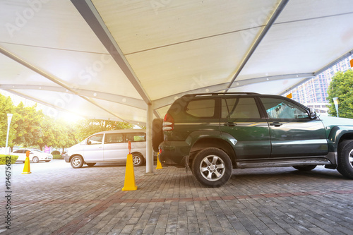 Outdoor parking in a residential area, several cars parked in a square