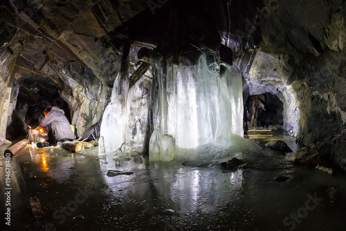 Frozen waterfall in a stone cave