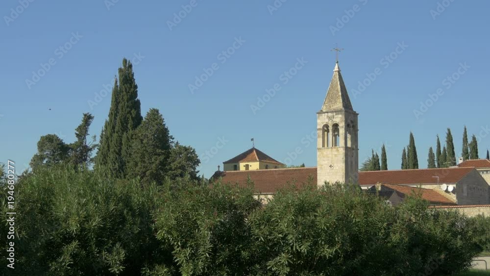 Old tower seen behind green branches Old tower seen behind green branches