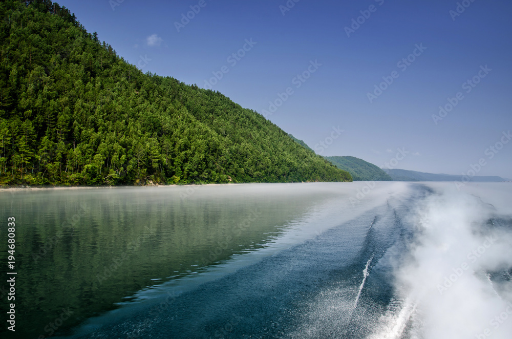 Background water surface behind of fast moving motor boat in lake Baikal, Russia