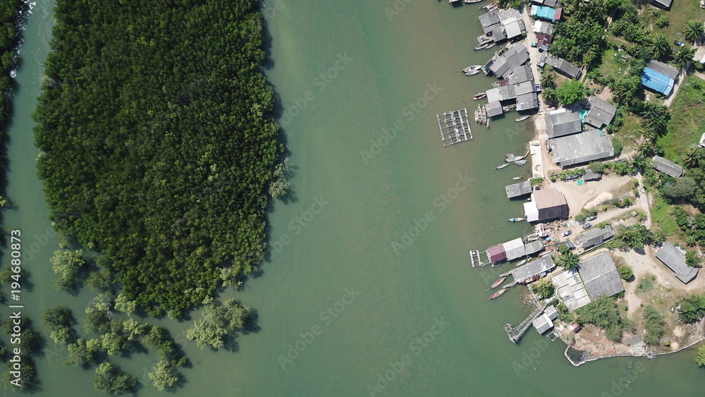 Aerial photo fishing village in Thailand. Fishing boats and fish farm