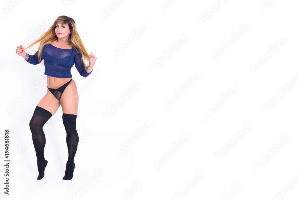Portrait of mature woman stretching her arms and looking away at gym. Fitness, stretching workout, attractive mature happy woman working out in sports club, keeping fit Portrait of mature woman stretching her arms and looking away at gym. Fitness, stretching workout, attractive mature happy woman working out in sports club, keeping fit