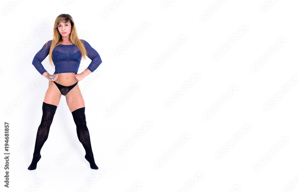 Portrait of mature woman stretching her arms and looking away at gym. Fitness, stretching workout, attractive mature happy woman working out in sports club, keeping fit Portrait of mature woman stretching her arms and looking away at gym. Fitness, stretching workout, attractive mature happy woman working out in sports club, keeping fit
