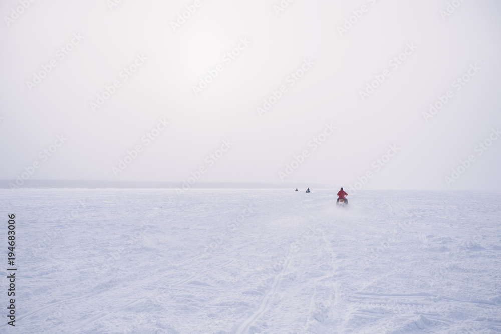 Naklejka premium People in atv quad bike. Winter snow field
