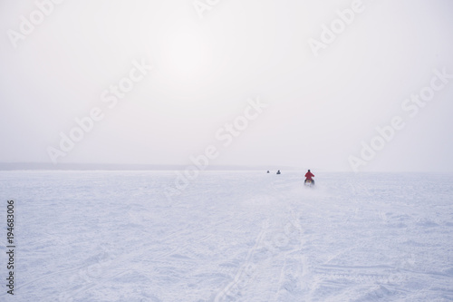 People in atv quad bike. Winter snow field