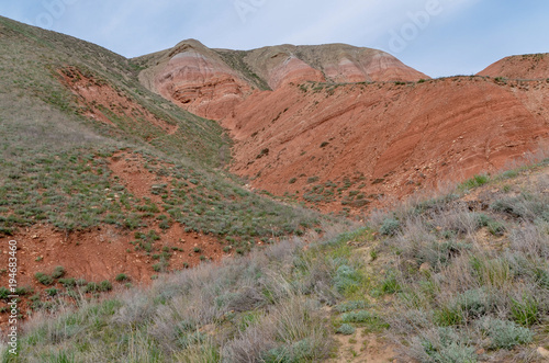 red sandstone outcrops on the slopes of Big Bogdo sacred mountain in Caspian steppe Bogdo-Baskunchak nature reserve, Astrakhan region, Russia