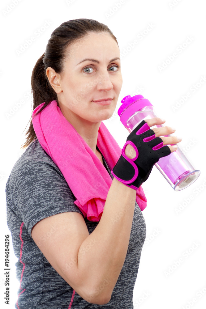 Working out and staying in good health at any age concept with happy mature woman drinking from a bottle of water after an exercise, isolated on white background with a clipping path Working out and staying in good health at any age concept with happy mature woman drinking from a bottle of water after an exercise, isolated on white background with a clipping path