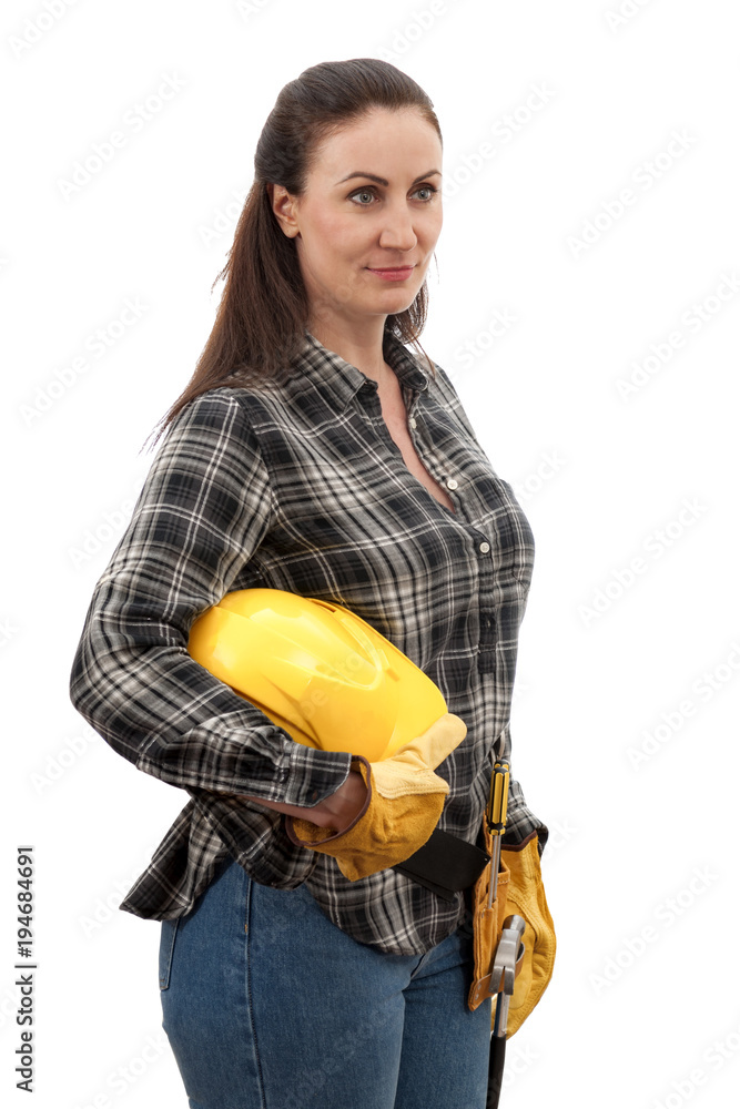 Construction work and home improvement jobs concept with a caucasian  brunette mature woman wearing jeans, hard hat, tool belt and other safety  equipment, isolated on white with clipping path Stock Photo