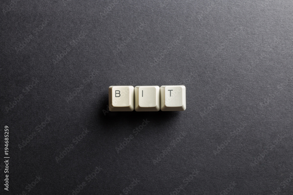 Word bit made using computer keyboard buttons on a black background. Basic unit of information. IT technology concept. Word bit made using computer keyboard buttons on a black background. Basic unit of information. IT technology concept.